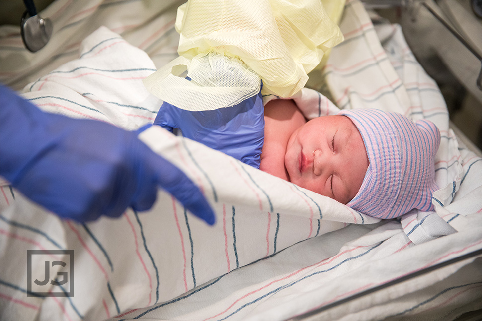 birth photography swaddling the newborn