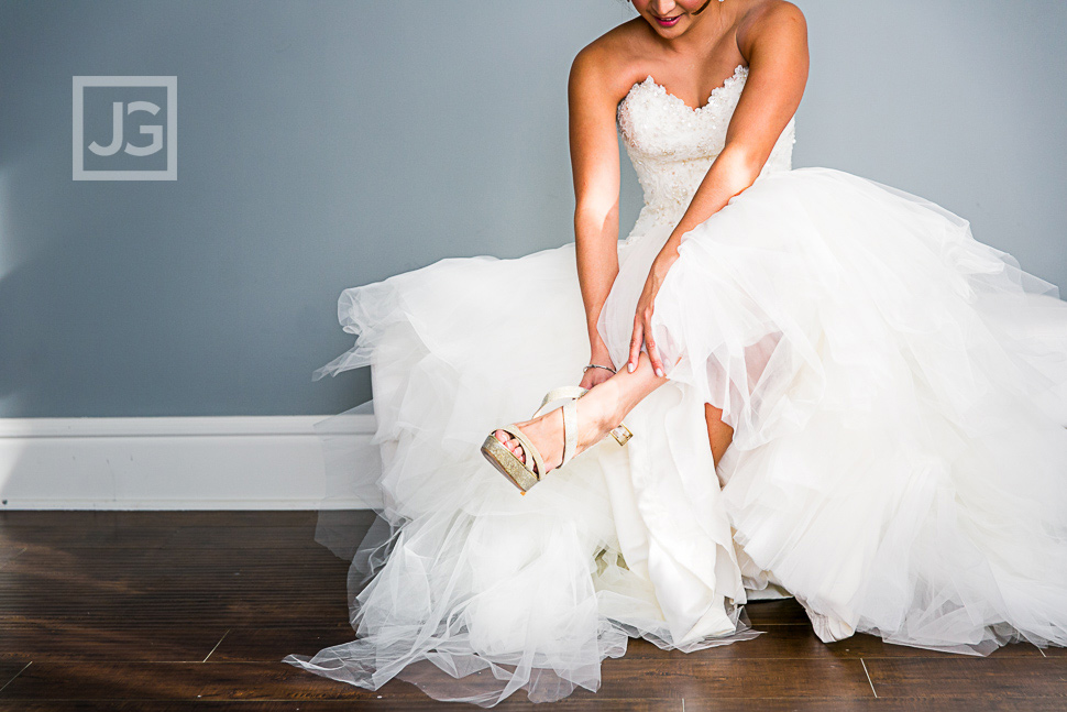 Bride putting on her Jimmy Choos