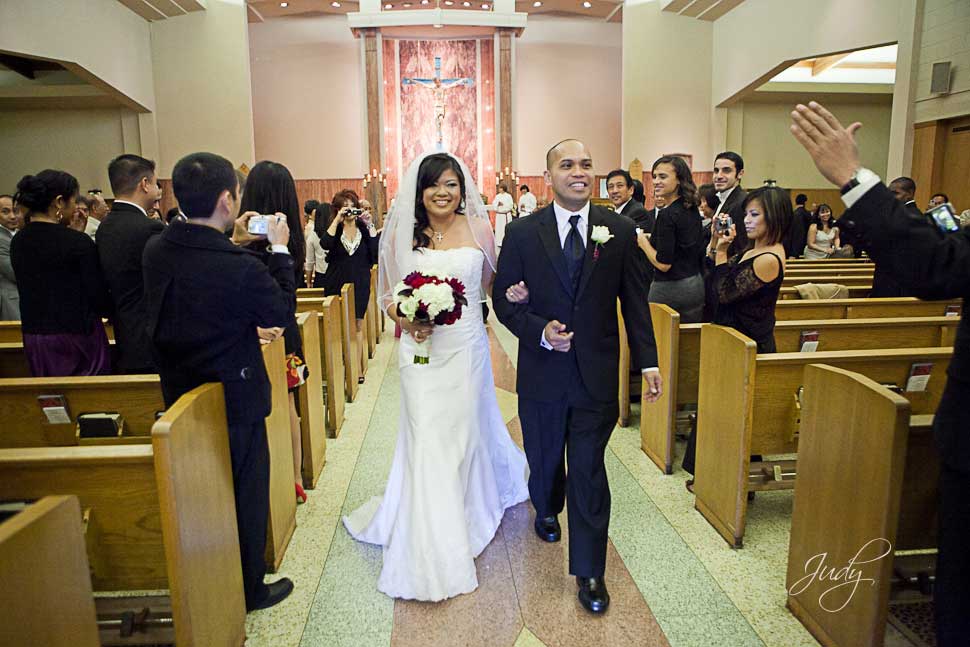 The Mr and Mrs at the end of their catholic wedding ceremony