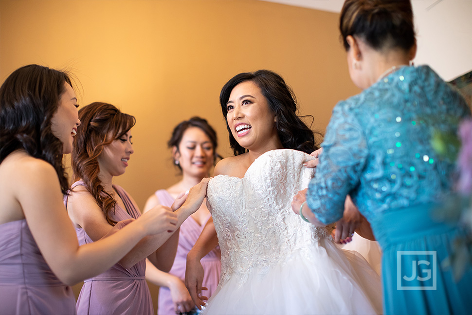 Bride getting in her dress