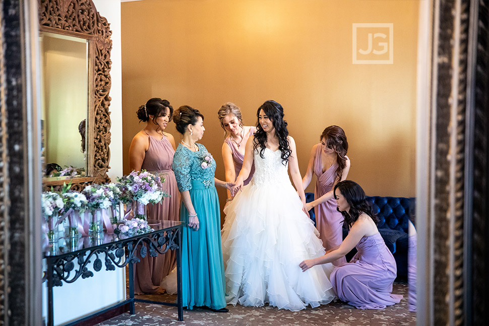 Bride getting in her dress