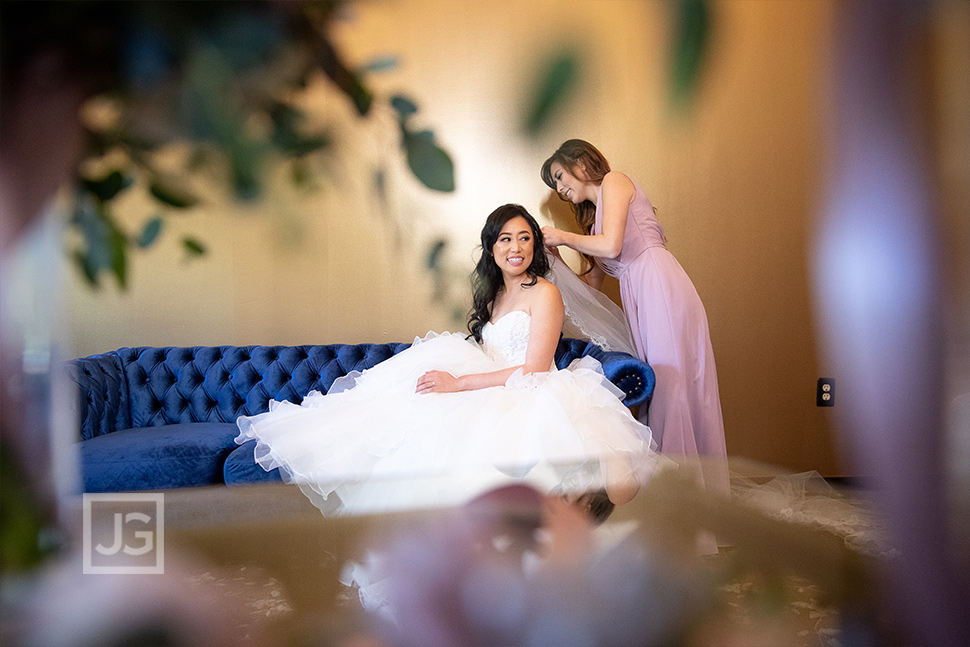 Bride putting on her veil