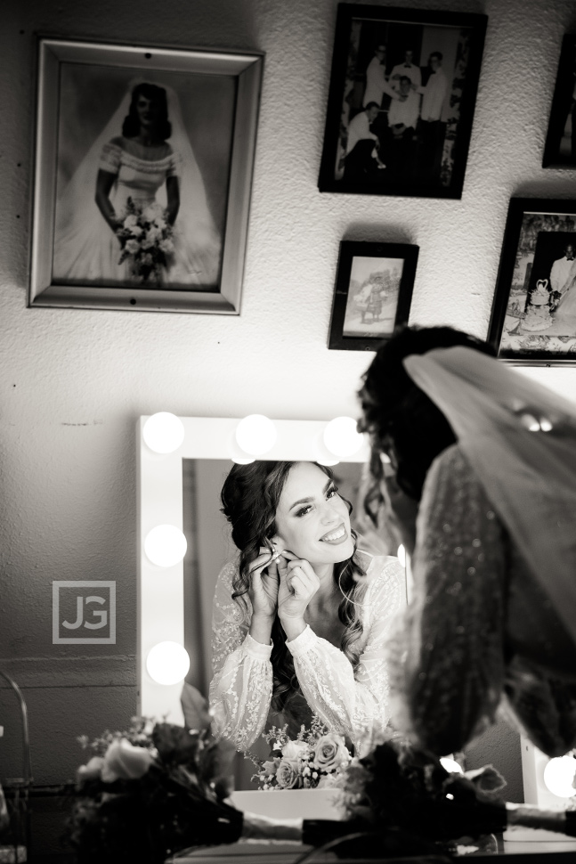 Bride putting on earrings