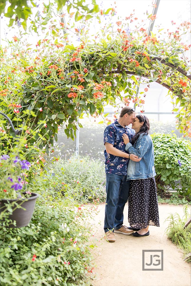 Kissing under an arch in the butterfly garden