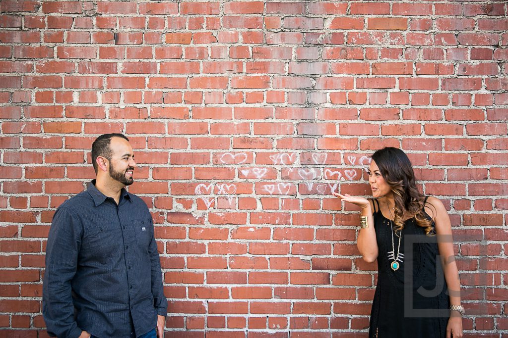 downtown Laguna Beach engagement photo brick wall