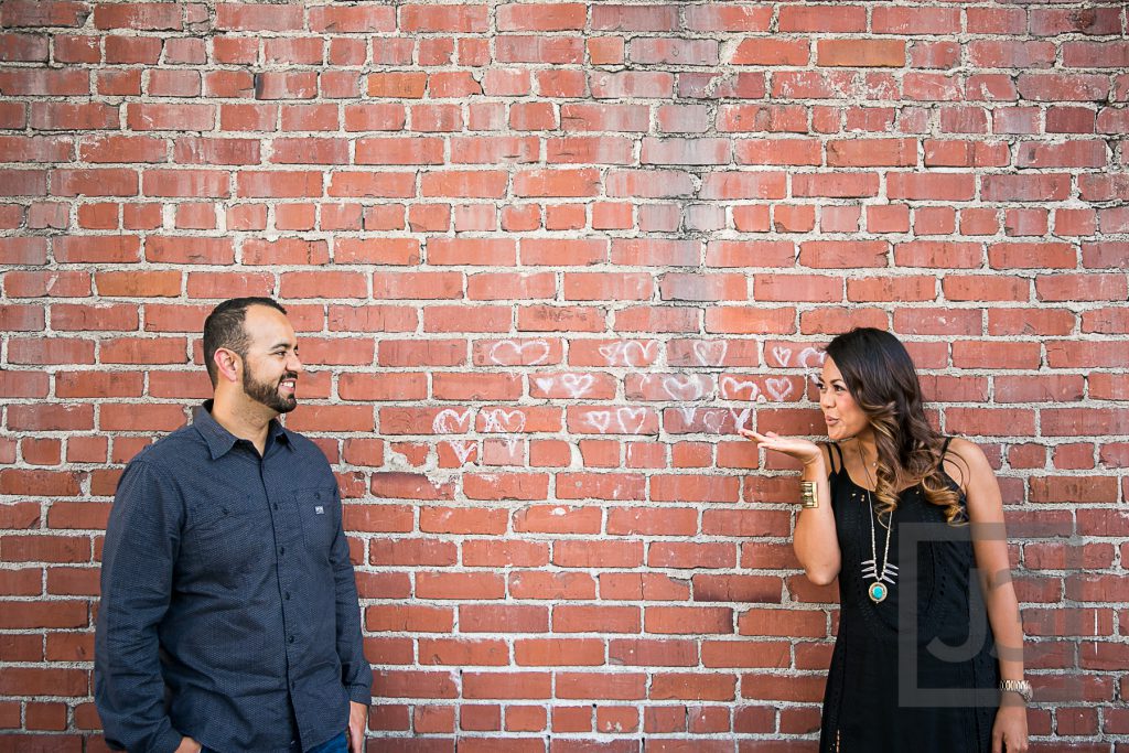 downtown Laguna Beach engagement photo brick wall